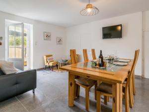 a dining room with a wooden table and chairs at Gîte Indépendant au Calme avec Jardin et Wifi, à 12 km des Plages - FR-1-306-1287 in Fresnay-en-Retz