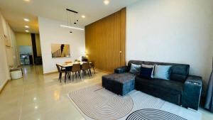 a living room with a couch and a dining room at Vela house hatyai 2 in Hat Yai +46 photos