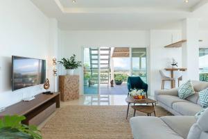 a living room with a couch and a tv at V270 Best View In Phuket Hot Tub Great Location in Ban Saiyuan (1)