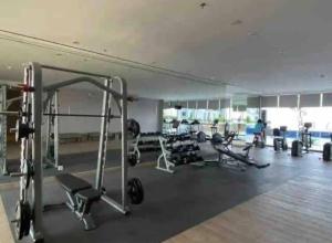 a gym with a lot of equipment in a room at Aesthetic korean apartment 2 BR in Surabaya
