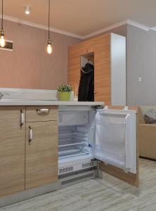 an empty kitchen with an open refrigerator at Divona Studio in Ruse