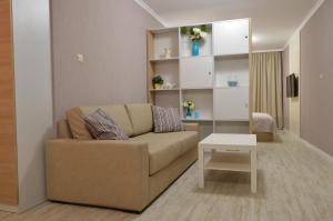 a living room with a couch and a table at Divona Studio in Ruse