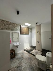 łazienka z toaletą i umywalką w obiekcie The PALM Green Ubud w mieście Ubud