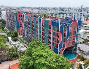a building with colorful paint on the side of it at Cybiq Ratchada 32 by Pikul in Bangkok