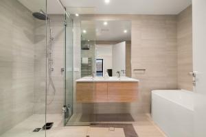 a bathroom with a shower and a sink and a tub at WARNING Extreme views 4 bed 3 bath luxury in Queenstown +19 photos