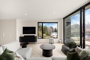 a living room with a couch and a piano at WARNING Extreme views 4 bed 3 bath luxury in Queenstown