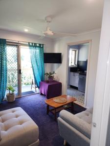 a living room with a couch and a table at Bushland View Retreat in Ocean Shores