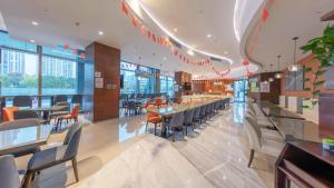 a dining room with tables and chairs in a restaurant at Holiday Inn Express - Suzhou Industrial Park by IHG in Suzhou