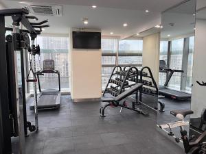 a gym with several tread machines and a flat screen tv at Holiday Inn Express - Suzhou Industrial Park by IHG in Suzhou