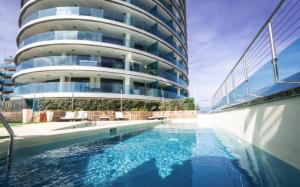 a building with a swimming pool in front of a building at Ocean Spa Plaza Luxury Suite in Gibraltar +10 photos