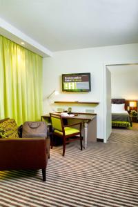 a hotel room with a desk and a bed at Hotel Ambassador Kaluga in Kaluga