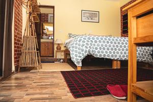 a bedroom with a bed and a rug at Les Terrasses Himalayan Resort in Charikot