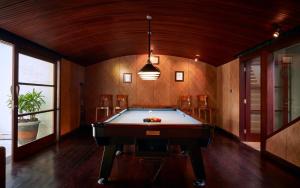 a pool table in the middle of a room at Pushpapuri Villa in Ketewel