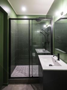 a bathroom with a shower and a white sink at LUZ 03 room in Bologna