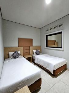 Postel nebo postele na pokoji v ubytování Airlangga Hotel + 37 fotografií
