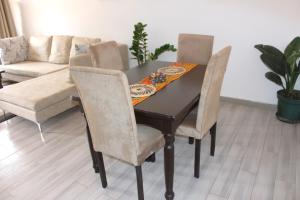 a dining room table with chairs and a couch at Busisiwe's RM Home in Lusaka