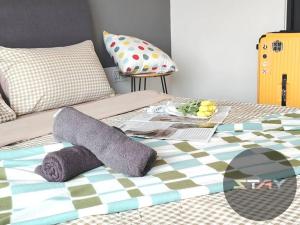 a bed with a blanket and pillows on it at Almas Suites 2Pax Cozy Neflix 100mbps BySTAY in Iskandar Puteri