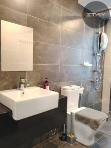 a bathroom with a white sink and a toilet at Almas Suites 2Pax Cozy Neflix 100mbps BySTAY in Iskandar Puteri
