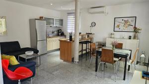 a kitchen and a living room with a table and chairs at 1 Haus Linden Osljak in Island Osljak