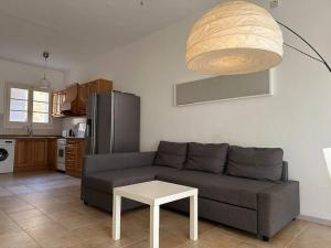 a living room with a couch and a table at Bizzilla - Family Friendly Maisonette in Xlendi