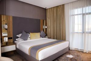 Voodi või voodid majutusasutuse Ramadi Hotel & فندق رمادي toas