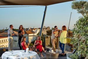 a group of people standing on a balcony at Occidental Faro in Faro