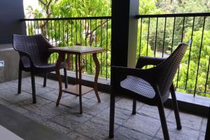 two chairs and a table on a balcony at Handagedara Resort & Spa in Mirissa