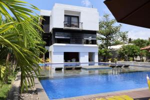 a house with a swimming pool in front of a building at Handagedara Resort & Spa in Mirissa