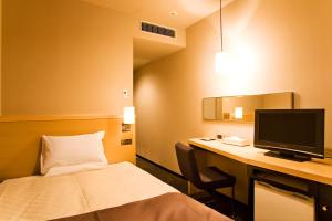 Postel nebo postele na pokoji v ubytování Hotel Metropolitan Morioka