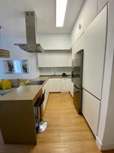 a kitchen with white cabinets and a counter top at Suite Beethoven in Santa Cruz de Tenerife