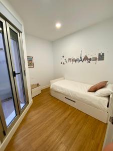 a bedroom with a bed and a large window at Suite Beethoven in Santa Cruz de Tenerife