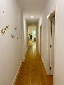 an empty hallway with white walls and wood floors at Suite Beethoven in Santa Cruz de Tenerife