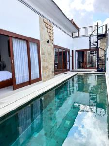 a swimming pool in a villa with a house at Jimbaran in Jimbaran
