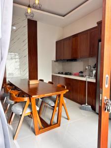 a kitchen with a wooden table and chairs at Jimbaran in Jimbaran