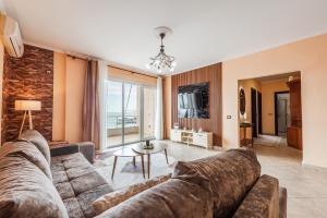 a living room with a couch and a table at Old Town 2BR with Sea View in Durrës