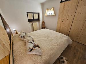 a bedroom with a bed with pillows on it at BellOretta Maison Champlas in Champlas du Col