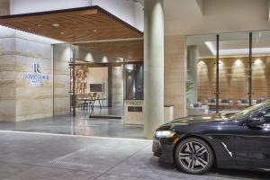 a black car parked in front of a building at Renaissance Honolulu Hotel & Spa in Honolulu