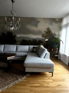 a living room with a couch and a chandelier at Nygatan in Mariehamn