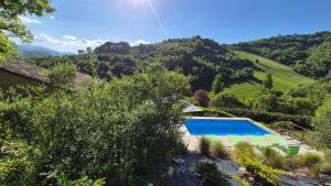 a villa with a swimming pool and a mountain at Borgo Canapegna - Boschetto - private pool exclusive use in Fabriano