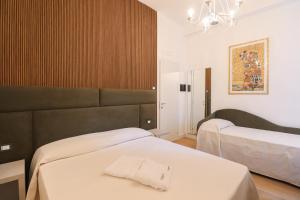Postel nebo postele na pokoji v ubytování Re Di Rhome Guest House