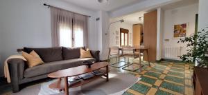 a living room with a couch and a table at Casa rural El Moral by Fuentelgato in Huerta del Marquesado