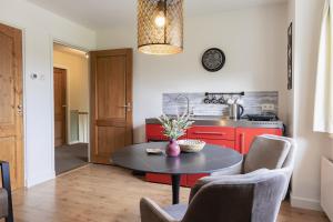a kitchen with a table with a vase on it at Appartement de Torenvalk in Grashoek