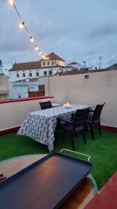 a table and chairs on the roof of a building at El Capricho Vasco-Andaluz in El Puerto de Santa María