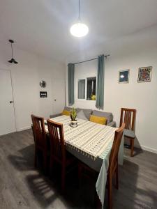 a dining room with a table and a couch at El Capricho Vasco-Andaluz in El Puerto de Santa María +14 photos