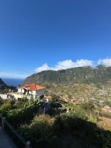 a house on top of a hill with a mountain at Casa Gonçalves in São Vicente