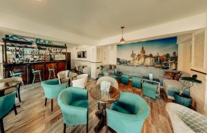 a restaurant with a bar with blue chairs and tables at Hotel Marea Neagra in Sinaia