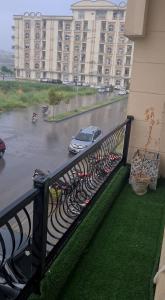 a balcony with a view of a car on a flooded street at Rivaj palace in Niāziān