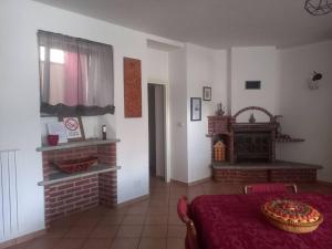 a living room with a table and a fireplace at Da Elena e Michele in Coazze