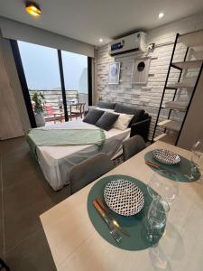 a room with two beds and a living room at Monoambiente con vista al rio in Posadas