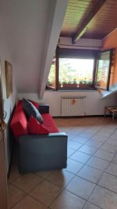 ein Wohnzimmer mit einem roten Sofa und einem Fenster in der Unterkunft CASA PAOLA - Stazione 400 Mt - free Wifi in Arcore